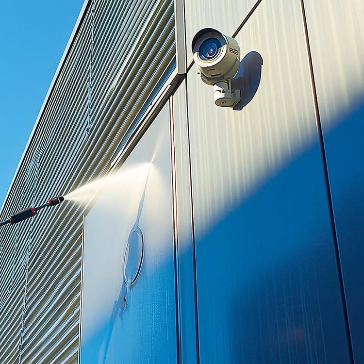 Cleaning a warehouse building with a jet wash